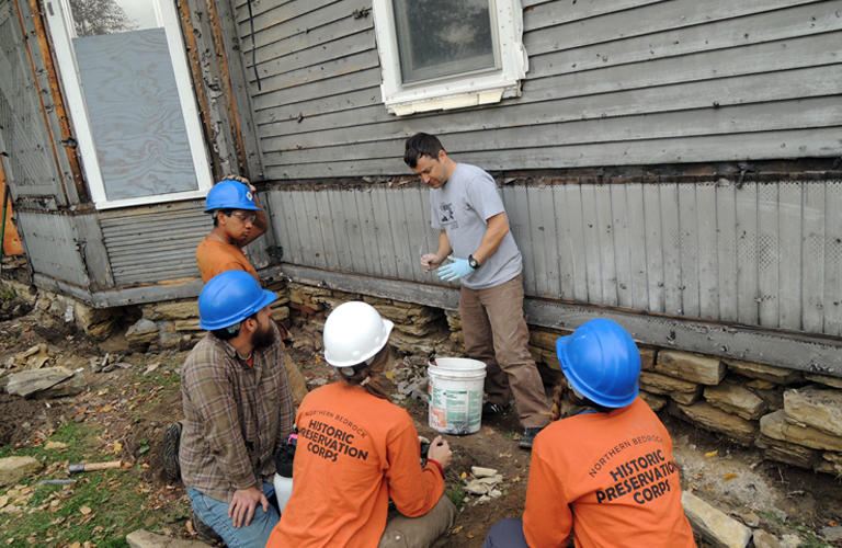 The Northwest Bedrock Historic Preservation Corps working on the preservation of 767 E 4th.