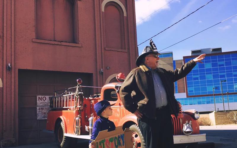 Saint Paul historian Jim Sazevich and young helper address in 2016 a community gathering to protest the threatened demolition of Hope Engine Co. No. 3, the city's oldest municipal building, constructed in 1872. 