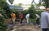 Volunteers filling up the excavation unit with soil 