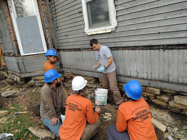 The Northwest Bedrock Historic Preservation Corps working on the preservation of 767 E 4th.